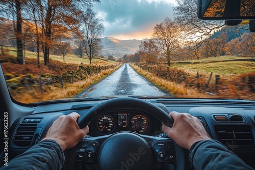 Man driving car on country road in autumn