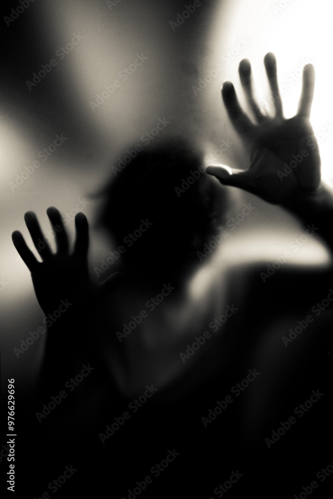 Scary picture of hands behind glass, horror ghost behind door, Halloween concept Scary picture of hands behind glass, horror ghost behind door, Halloween concept