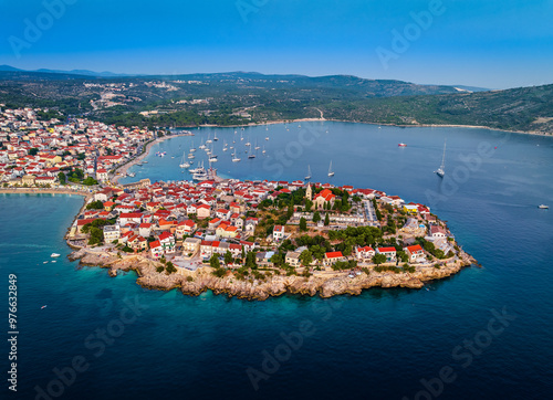 Primosten, Croatia - Aerial view of Primosten peninsula and old town with red rooftops and St. George's Church on a sunny summer morning in Dalmatia, Croatia. Clear blue sky on the Adriatic sea coast