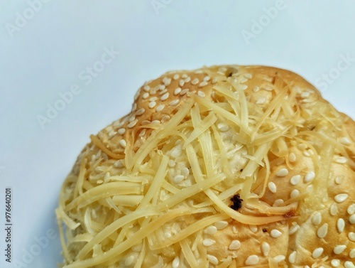 Round shaped bread with sesame topping and grated cheese topped with chocolate filling. on a white background photo