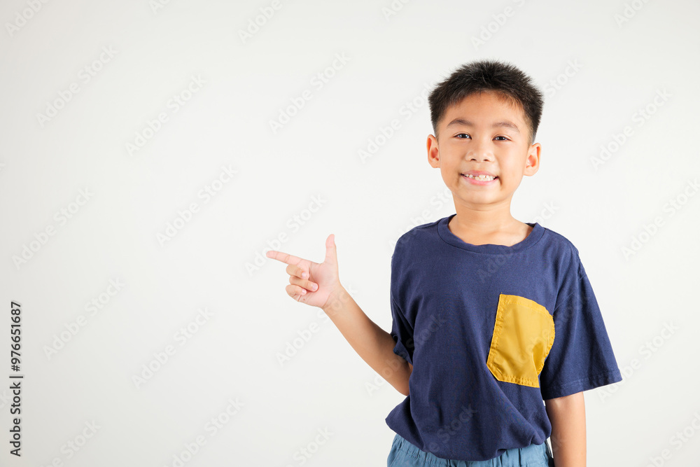 Happy Asian portrait cute young kid boy smiling indicate finger empty space, studio shot isolated on white background, Thai primary child pointing index out with copy space Happy Asian portrait cute young kid boy smiling indicate finger empty space, studio shot isolated on white background, Thai primary child pointing index out with copy space
