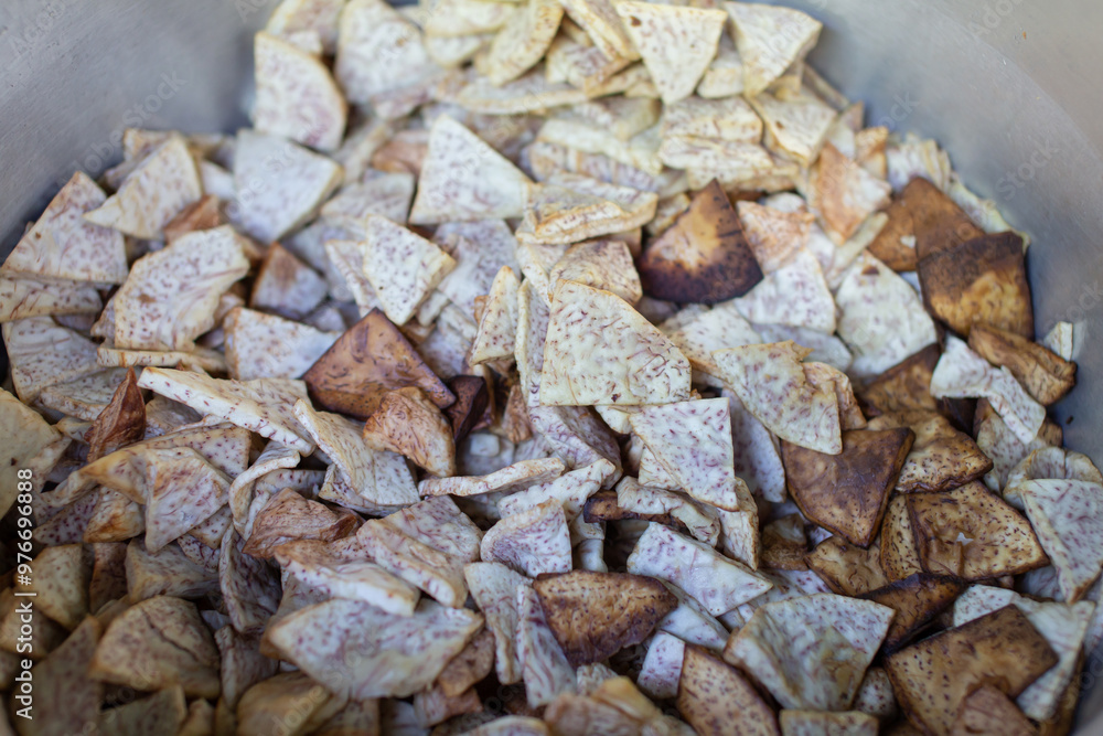 Lots of taro slices in a metal pan. Lots of taro slices in a metal pan.