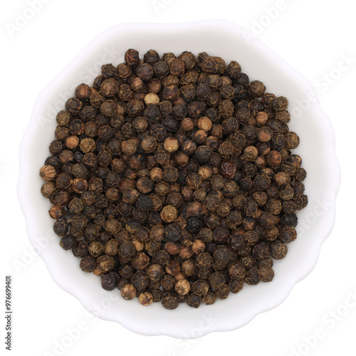 Round black pepper in a white plate. Spice for cooking