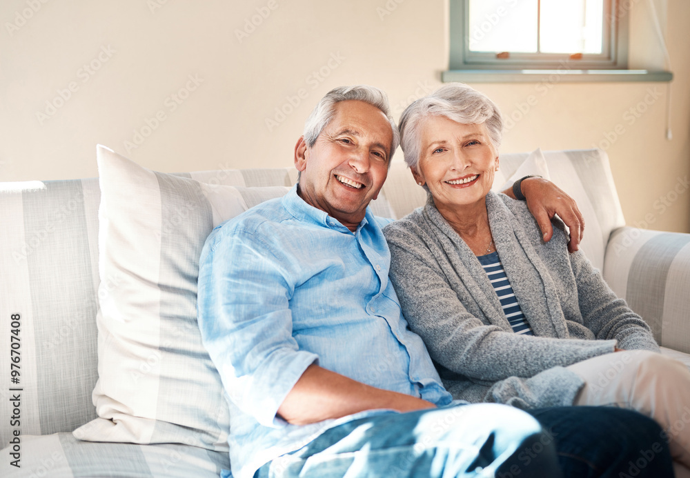Obraz premium Hug, portrait and happy senior couple on sofa for connection, bonding and relaxing together at home. Smile, love and elderly man and woman hugging for resting in living room at house in Switzerland.