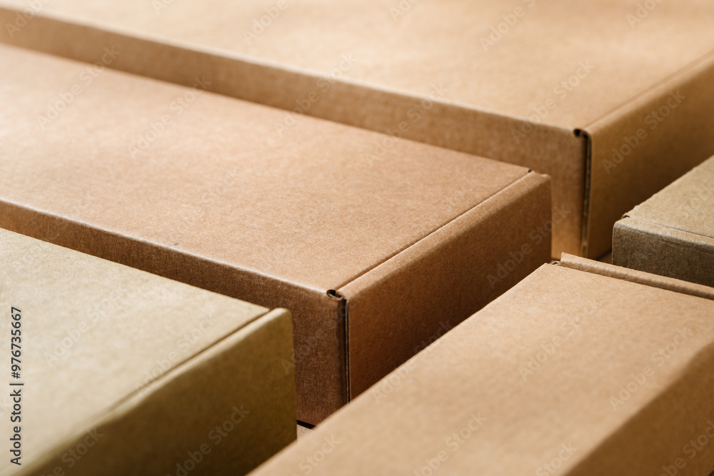 Stacked cardboard boxes on a neutral background in a shipping or packaging setting Stacked cardboard boxes on a neutral background in a shipping or packaging setting