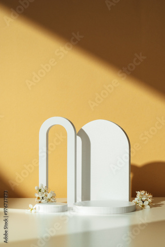 Modern White Geometric Shapes and Flowers on Table Against Orange Wall