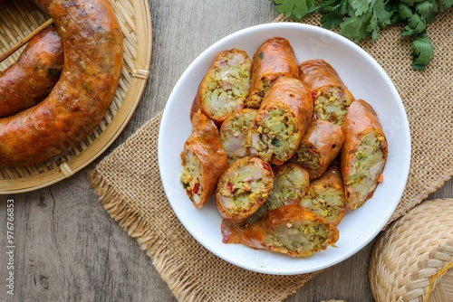 Northern Thai Sausage in a white plate on wooden background, thai called Sai Oua photo