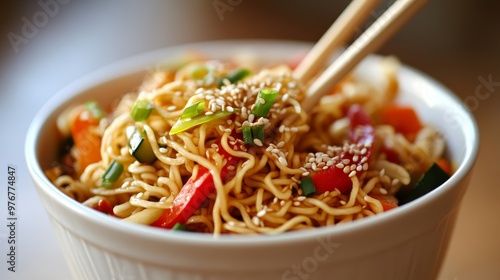 93. Detailed shot of a bowl of chow mein noodles with colorful vegetables, topped with sesame seeds and green onions, presented with wooden chopsticks photo