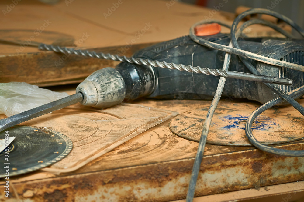 Electric hammer drill on metal surface with drills. Construction Electric hammer drill on metal surface with drills. Construction