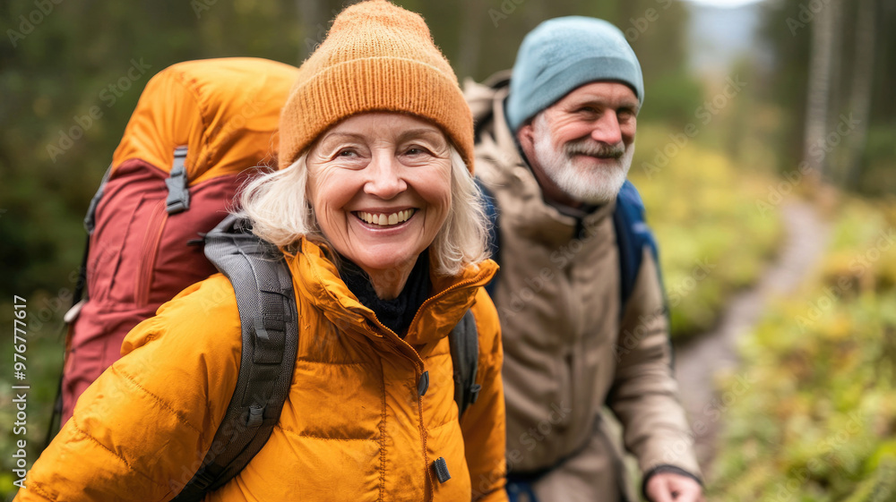 Elderly couple smiling while hiking on a scenic trail enjoying the outdoors Elderly couple smiling while hiking on a scenic trail enjoying the outdoors