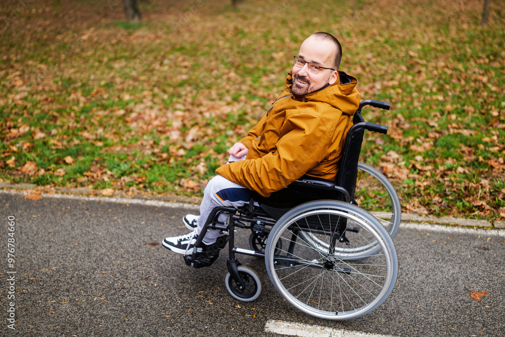 Portrait of happy paraplegic handicapped man in wheelchair in park. Portrait of happy paraplegic handicapped man in wheelchair in park.