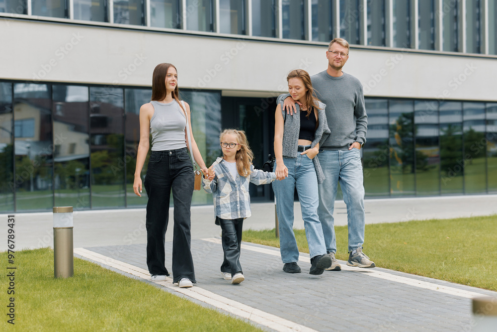 Fototapeta premium Portrait of a happy family with children walking around the city on a weekend