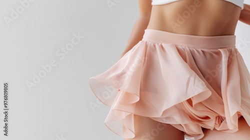 Intimate cosmetic and weight-loss concept, with a focus on a woman’s perfect hips and abdomen, elegantly covered in chiffon, against a bright white background.
