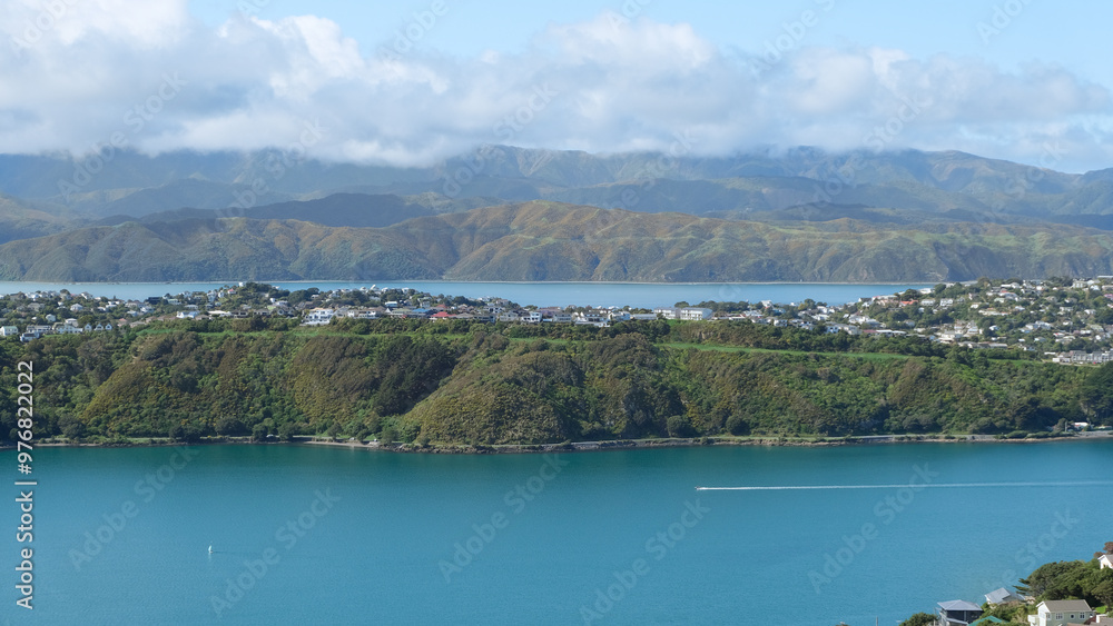 Fototapeta premium Scenic aerial view of Miramar Peninsula with houses overlooking ocean and rugged hills in capital city of Wellington, New Zealand Aotearoa