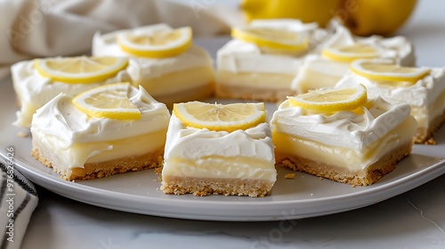 On a grey platter neatly sliced lemon bars covered in frosting