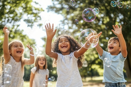 Fototapeta Naklejka Na Ścianę i Meble -  Joyful Children Chasing Bubbles in the Park