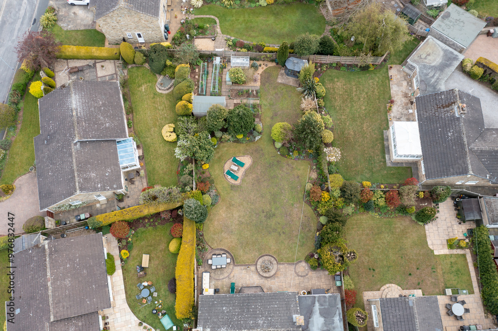 Aerial photo of a typical housing estate in the village of Boston Spa in Leeds West Yorkshire showing gardens of typical British homes in the summer Aerial photo of a typical housing estate in the village of Boston Spa in Leeds West Yorkshire showing gardens of typical British homes in the summer
