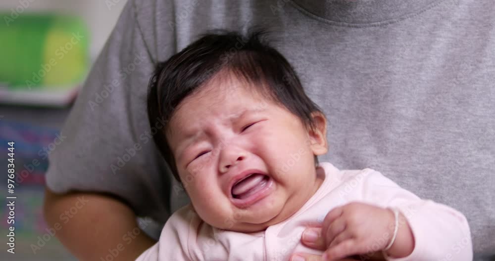 Newborn infant crying and calming down while still whining, stretching, and even looking at the things in front of her. Newborn infant crying and calming down while still whining, stretching, and even looking at the things in front of her.