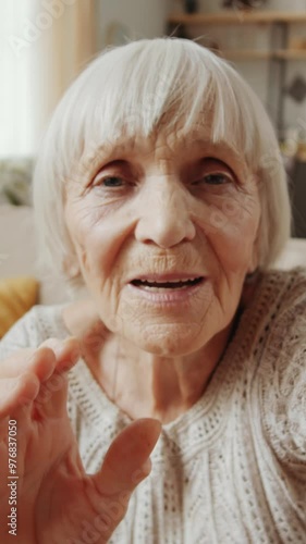 Wallpaper Mural Vertical close-up shot of senior woman with grey hair waving at camera and communicating on video call while using social media on smartphone Torontodigital.ca