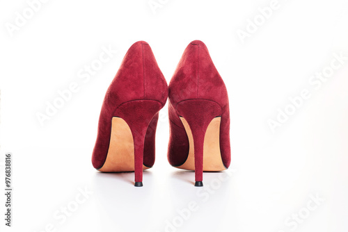 Close up of red high heel shoes on white background. Female stiletto heels in suede leather, back view