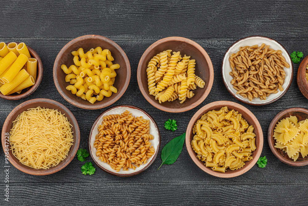 Pasta. Various kinds of uncooked pasta and noodles over wooden background. Traditional Italian Pasta. Various kinds of uncooked pasta and noodles over wooden background. Traditional Italian