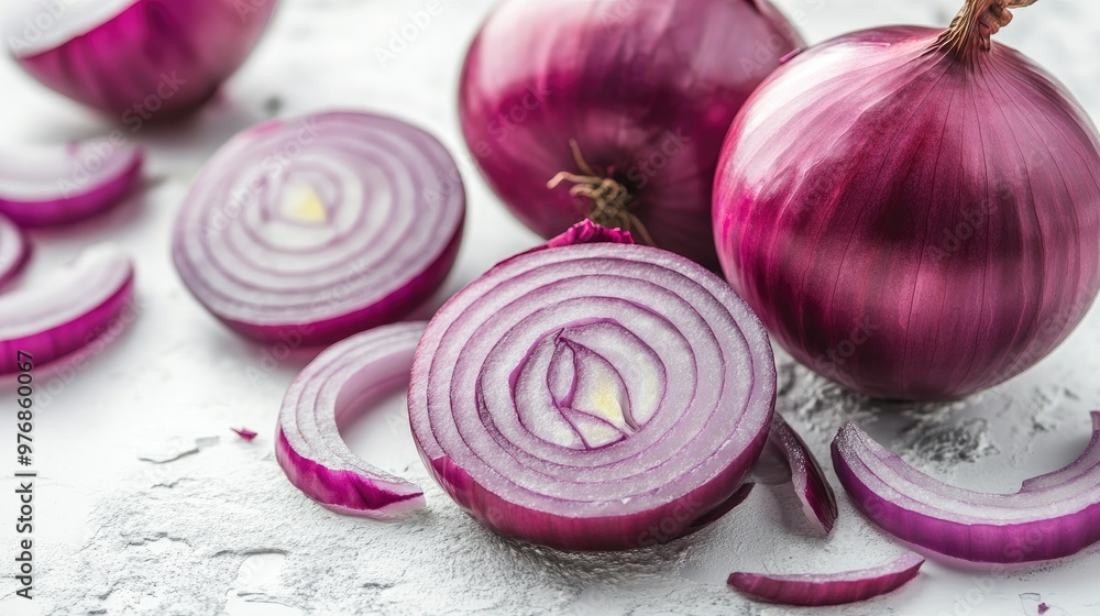 Close-up of whole and sliced red onion, with vibrant purple layers, arranged on a white surface. Focus on the fresh, juicy texture. Close-up of whole and sliced red onion, with vibrant purple layers, arranged on a white surface. Focus on the fresh, juicy texture.
