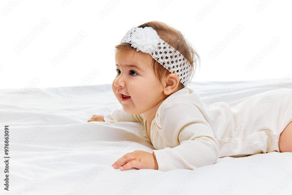 Charming little baby, dressed in cozy white outfit, gazes forward with curiosity, her headband adding sweet touch to her delicate features. Concept of beauty, parenthood, childhood, life and birth. Charming little baby, dressed in cozy white outfit, gazes forward with curiosity, her headband adding sweet touch to her delicate features. Concept of beauty, parenthood, childhood, life and birth.