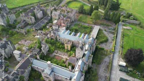 Haunted Denbigh Lunatic Asylum, North Wales, Aerial anticlockwise rotate from near and pull back, sunny afternoon
