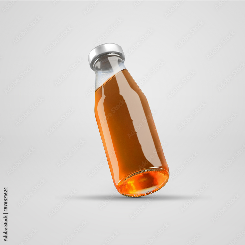 Fototapeta premium Mockup of glass transparent bottle with apple juice, with metal cap, presentation of container diagonally, isolated on white background.