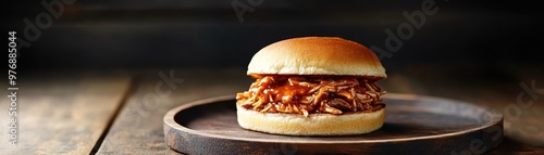 Delicious pulled pork sandwich served on a wooden plate, perfect for food lovers and culinary enthusiasts looking for comfort food. photo