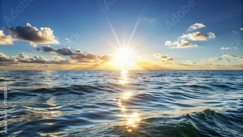 Sunset Over the Ocean, Warm Glow Reflecting on Water, Serene Coastal Atmosphere, Tranquil Natural Scene.