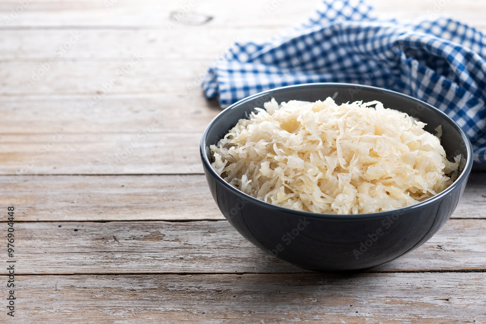Sauerkraut in a bowl on wooden table. Traditional german food. Copy space Sauerkraut in a bowl on wooden table. Traditional german food. Copy space