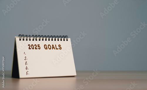 New year plans 2025. Text on Note Pad with calendar, Resolutions, plan, goals, action, checklist, idea concept. New Year 2025 template, copy space