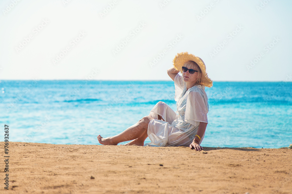 Woman in a hat on the seashore. Selective focus. Woman in a hat on the seashore. Selective focus.