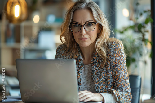 Focused Woman Working on Laptop in Office