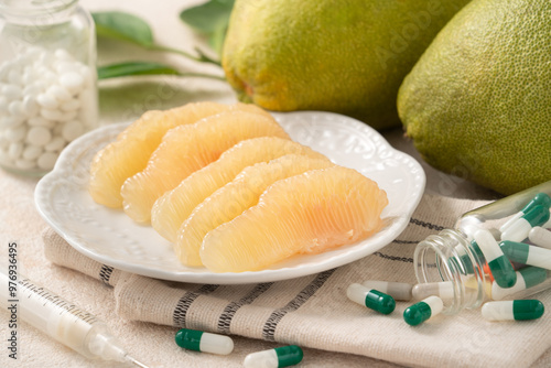 Fresh pomelo fruit and medicine adverse drug reaction interaction design concept.