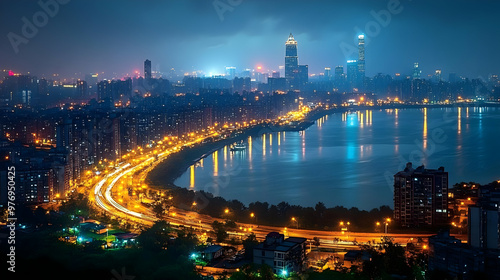 A panoramic view of a city skyline at night, with a large body of water in the foreground. The city lights illuminate the buildings and streets, creating a beautiful urban landscape.