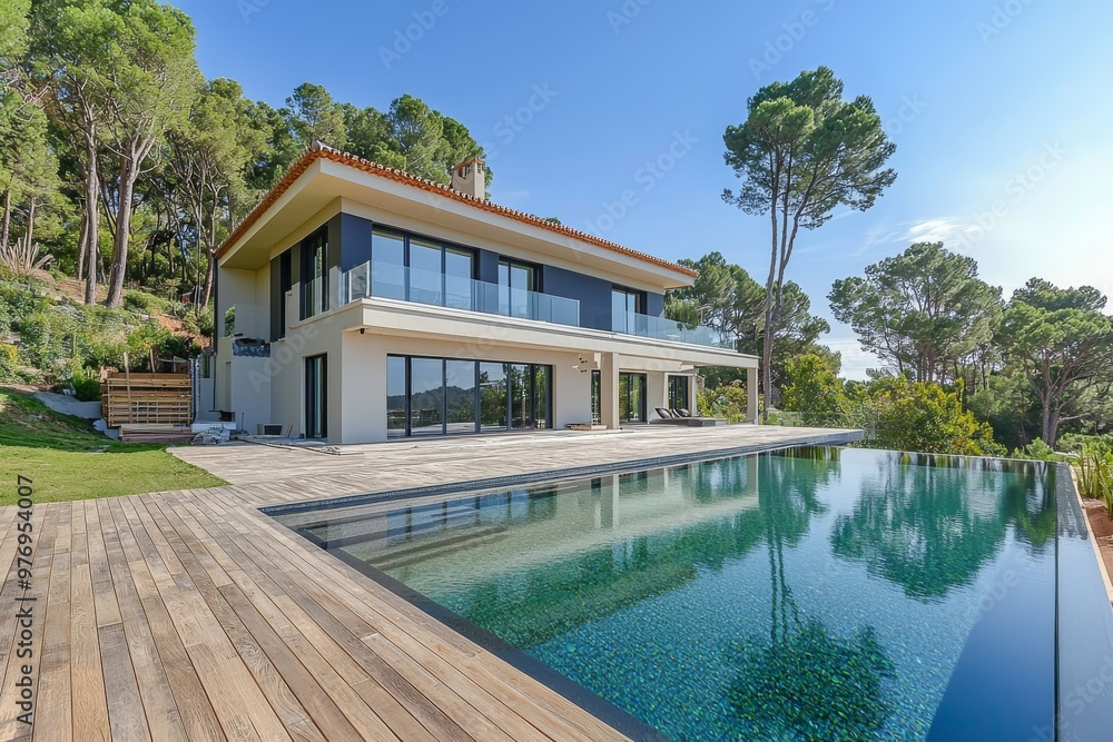 It has a beautiful modern white house with large windows overlooking a Mediterranean landscaped garden with palm trees and a blue swimming pool. This is a high tech style villa. It can be used as a It has a beautiful modern white house with large windows overlooking a Mediterranean landscaped garden with palm trees and a blue swimming pool. This is a high tech style villa. It can be used as a