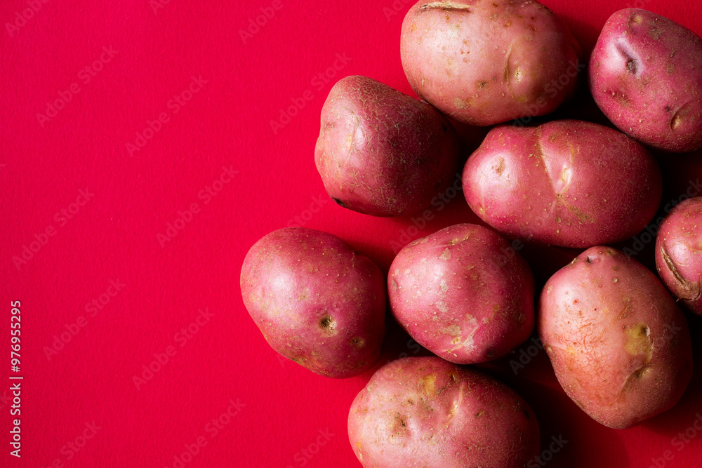Red potatoes against a red background Red potatoes against a red background