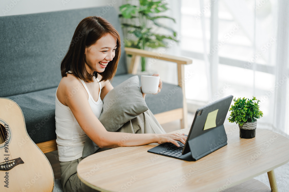 Smiling young woman uses social media to relax at home on the weekend. Relaxation concept Smiling young woman uses social media to relax at home on the weekend. Relaxation concept