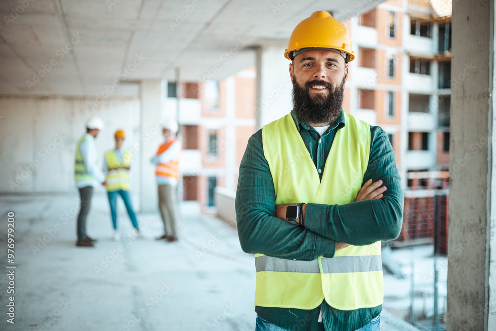 Confident Construction Worker at Building Site with Team Confident Construction Worker at Building Site with Team