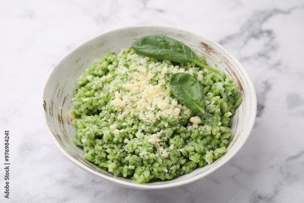 Tasty spinach risotto served on white marble table, closeup Tasty spinach risotto served on white marble table, closeup