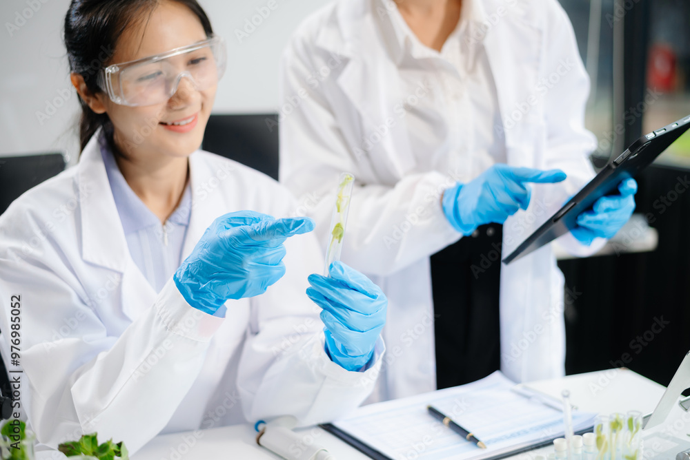 Two Asian scientists in a lab conducting food research using a microscope and lab equipment, showcasing innovation in food science Two Asian scientists in a lab conducting food research using a microscope and lab equipment, showcasing innovation in food science
