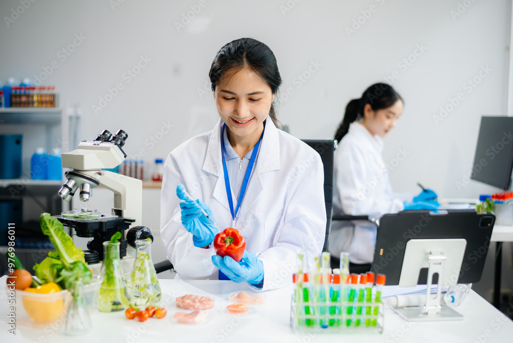 Two Asian scientists in a lab conducting food research using a microscope and lab equipment, showcasing innovation in food science Two Asian scientists in a lab conducting food research using a microscope and lab equipment, showcasing innovation in food science