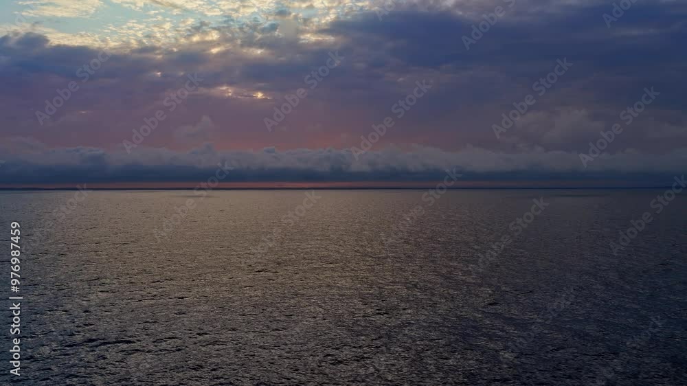 Breathtaking sunrise casting vibrant colors over the calm sea, on the horizon between the coast of Norway and Sweden, creating a serene coastal atmosphere. Breathtaking sunrise casting vibrant colors over the calm sea, on the horizon between the coast of Norway and Sweden, creating a serene coastal atmosphere.