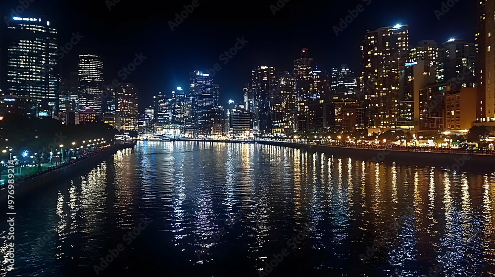 A vibrant cityscape at night with illuminated skyscrapers reflected in the water. A vibrant cityscape at night with illuminated skyscrapers reflected in the water.