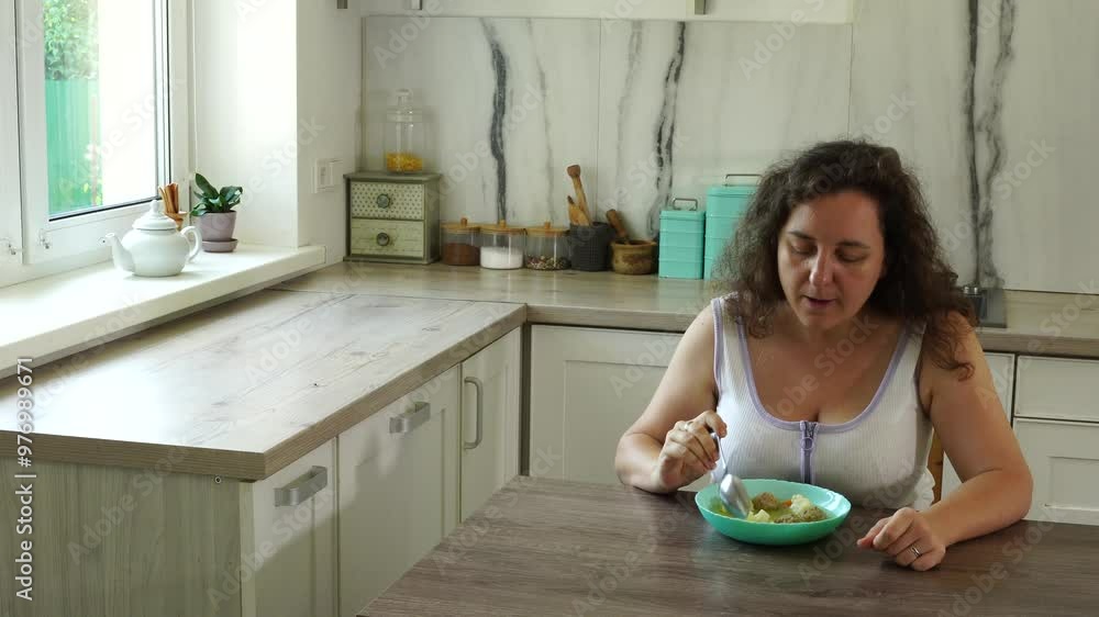 Woman eats soup with meatballs Woman eats soup with meatballs