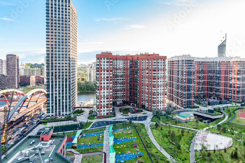 A new residential area in the capital Moscow Mnevniki and Filevsky Park with high-rise buildings and a bridge under construction across the Moskva River with a overhead view of Moscow City. photo