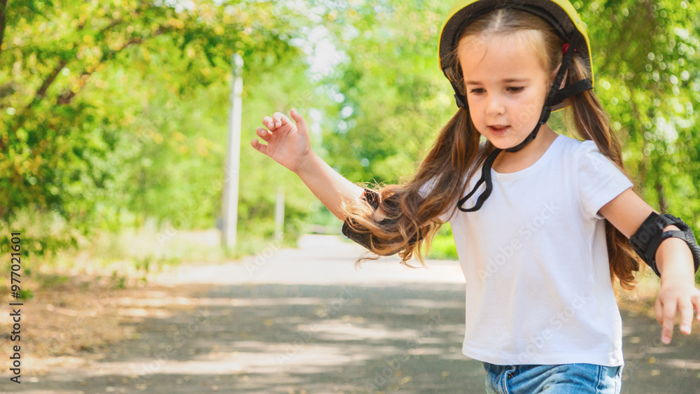 Girl skateboard with safety equipment - helmet, knee and elbow pads. Safe summer activity. Kids activity.