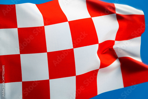 Checkered flag waving on blue background photo